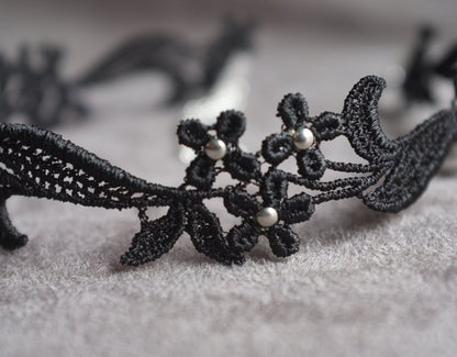 Black floral lace decorated with silver beads