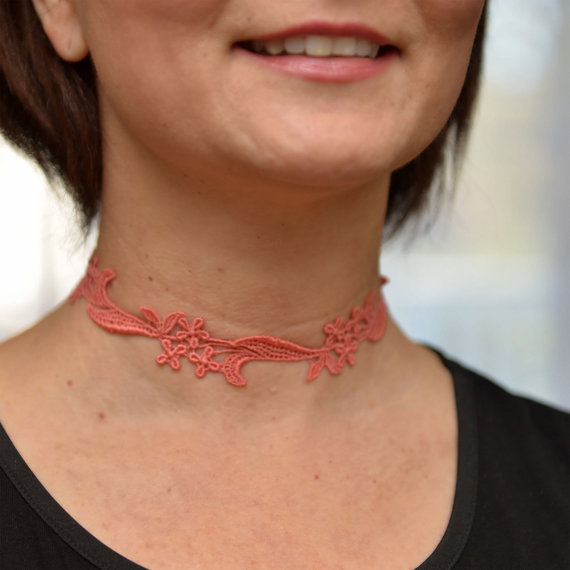  Woman wearing a Coral Pink Floral Lace Choker