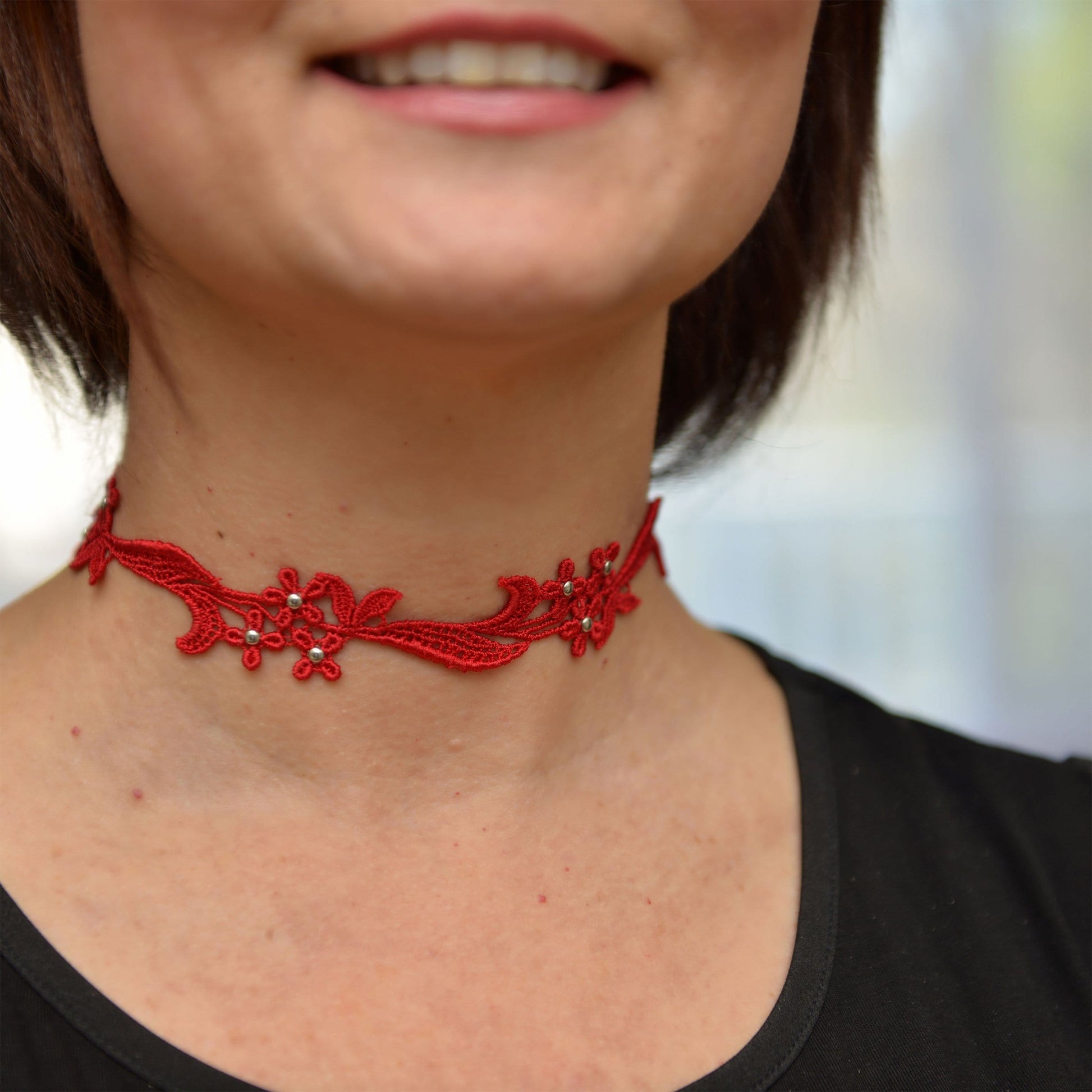 Lifestyle shot of the Read and Silver Sophia Lace Choker .